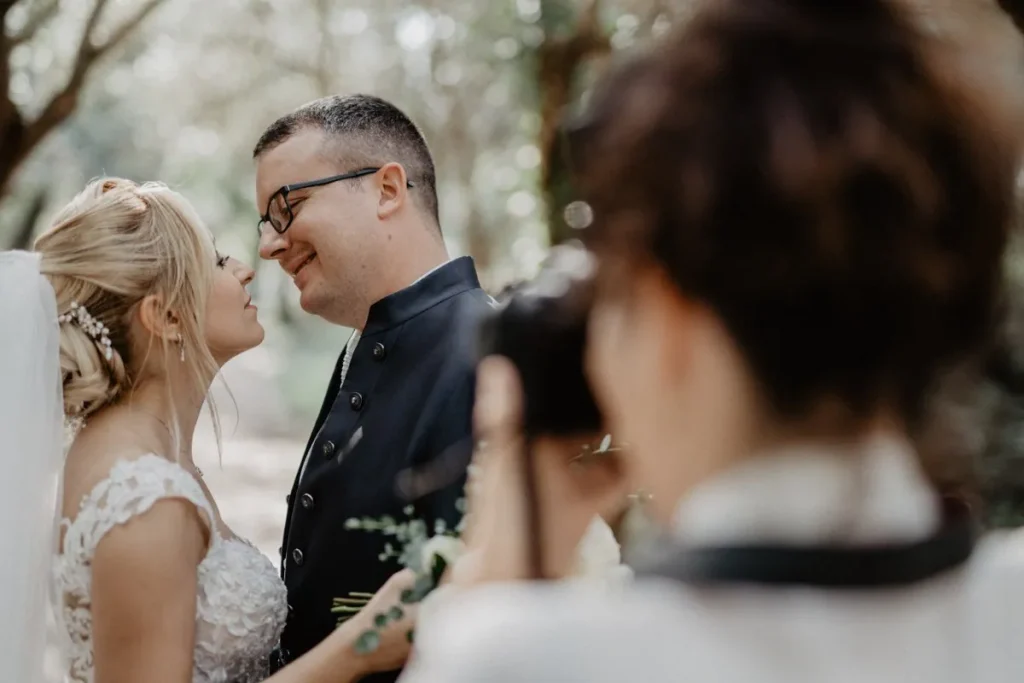 photographer is taking photos of a wedding couple