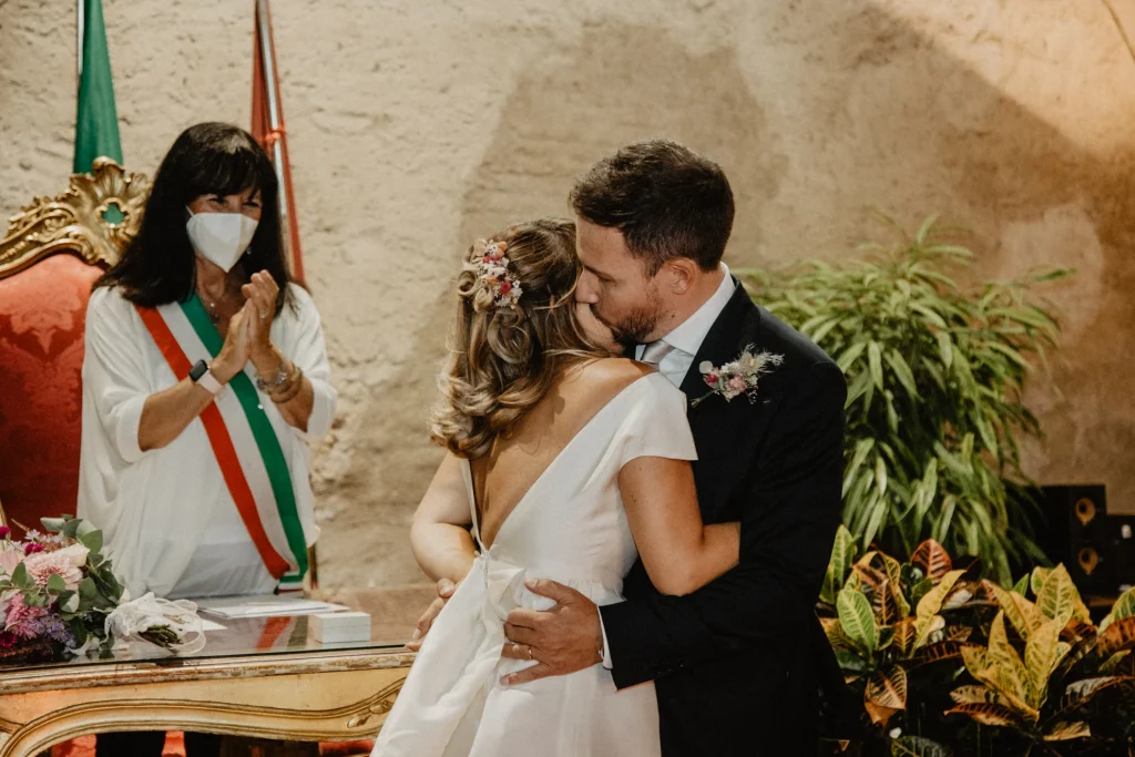 groom is kissing the bride during the ceremony