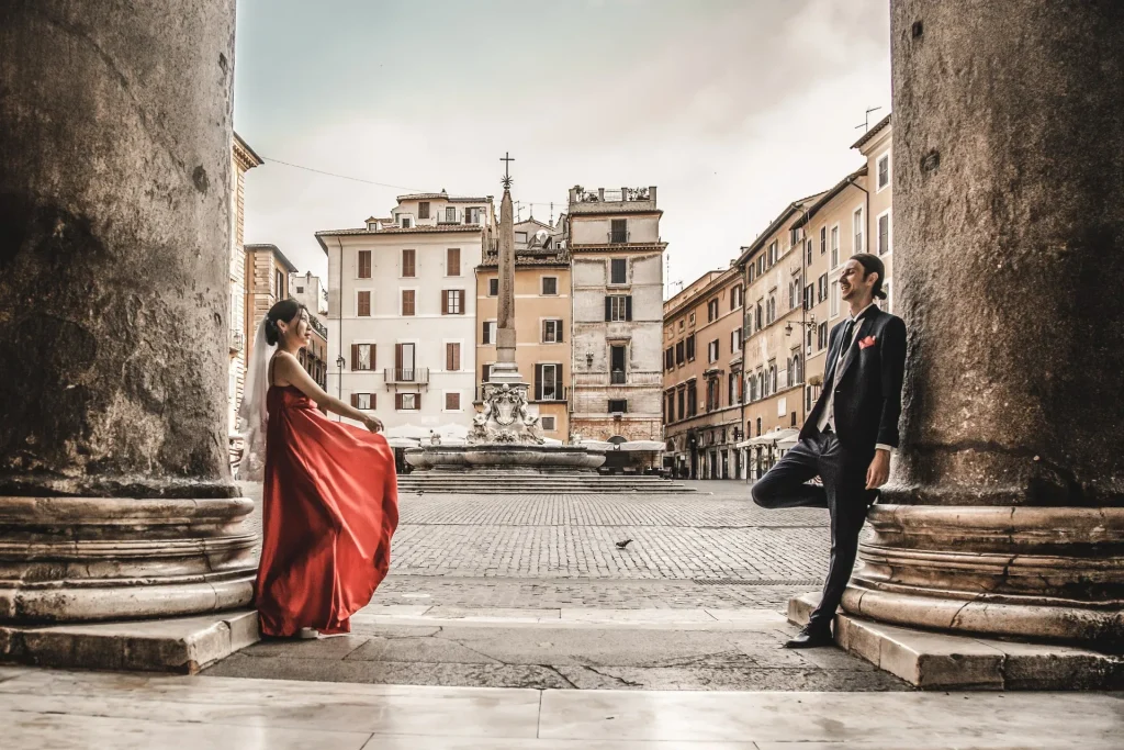 a man and a woman are in the Pantheon in Rome and they are lying against 2 columns