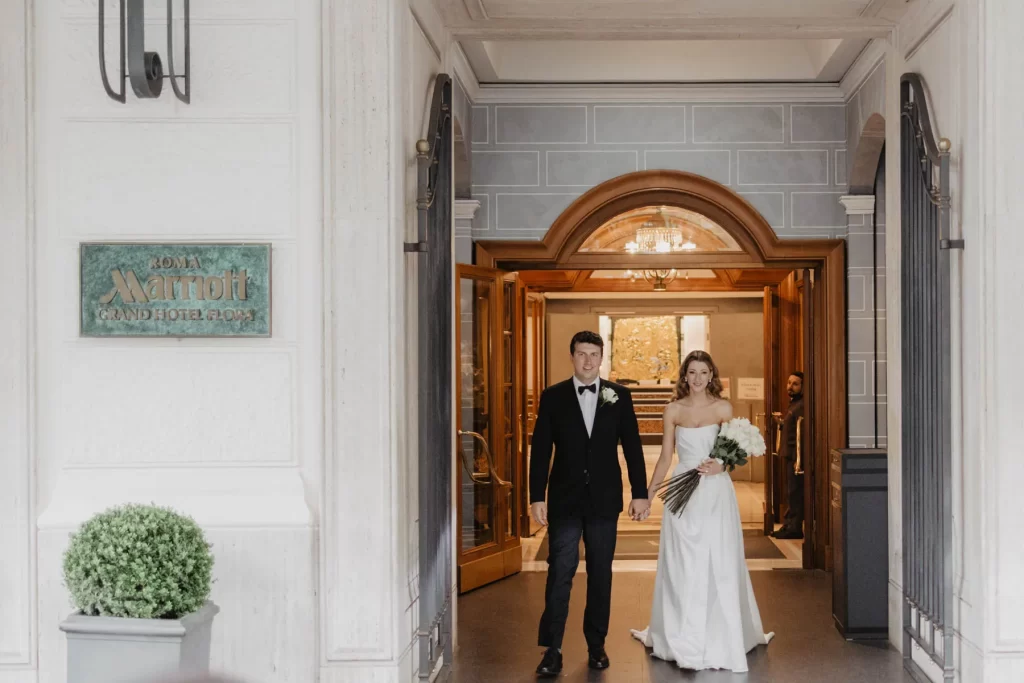 wedding couple at the entrance of Marriott Hotel Flora