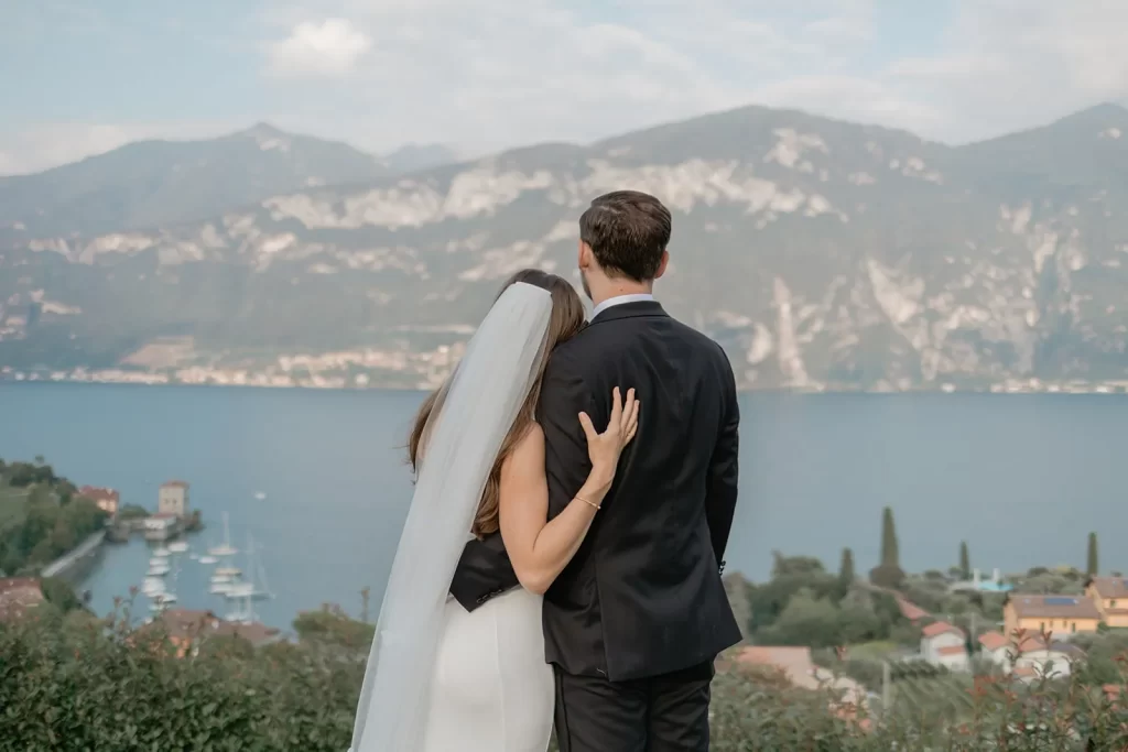 a wedding couple is hugging each other in Lake Como