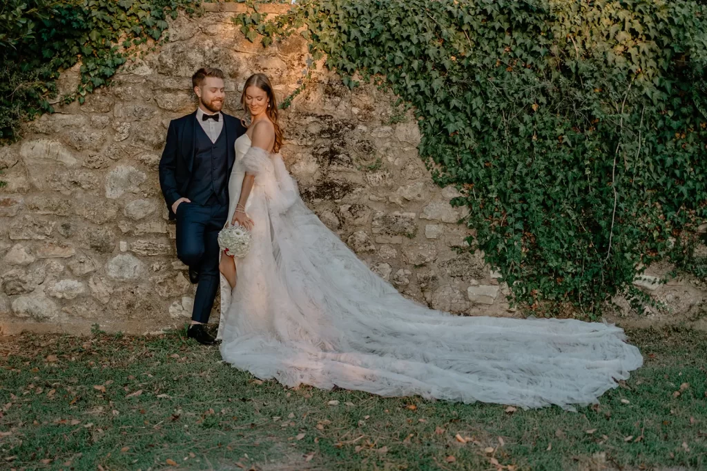 a wedding couple is hugging each other in Tuscany