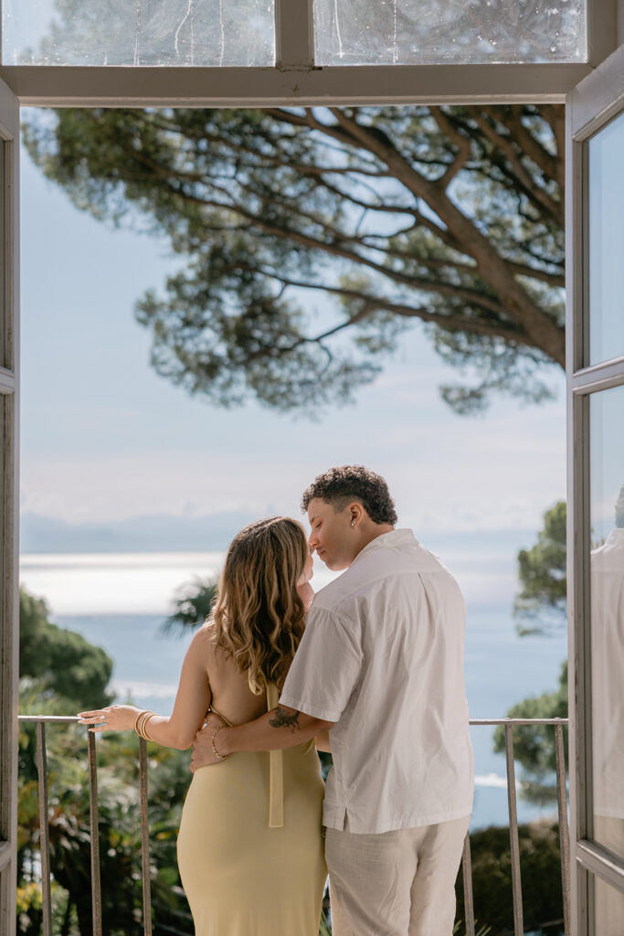 a couple is kissing each other overlooking Ravello coast