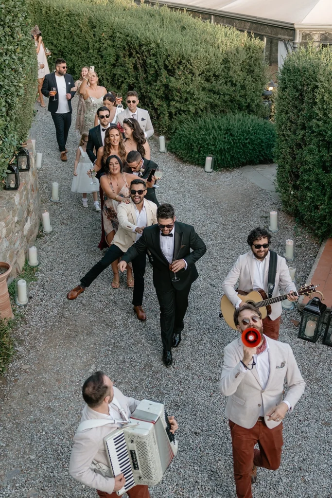 a group of people is walking in a garden