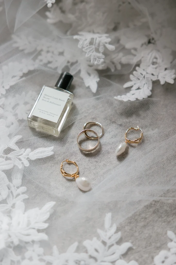 detail of weddings rings and a perfume