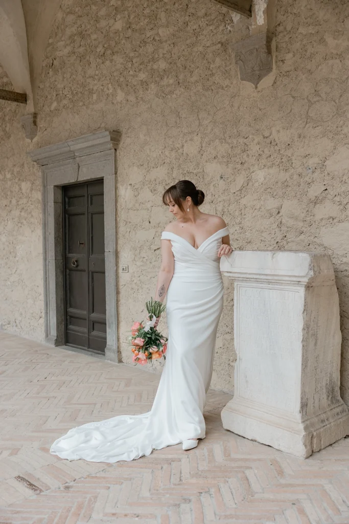 a bride is under the arches of Castello Odescalchi Bracciano