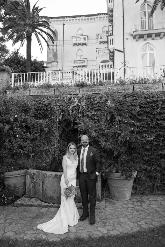 a couples is standing in front of Palazzo Avino Ravello