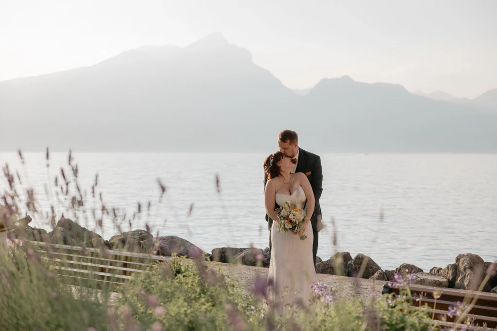 a newlywed couple is hugging Lake Garda