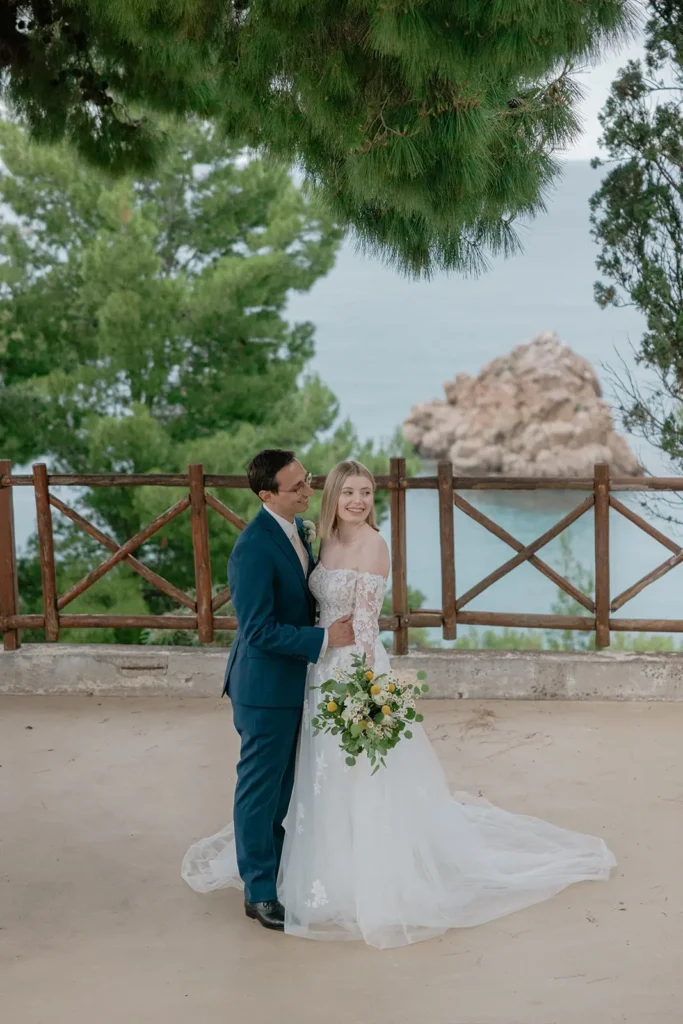 a newlywed couple with Sicilian sea in the background