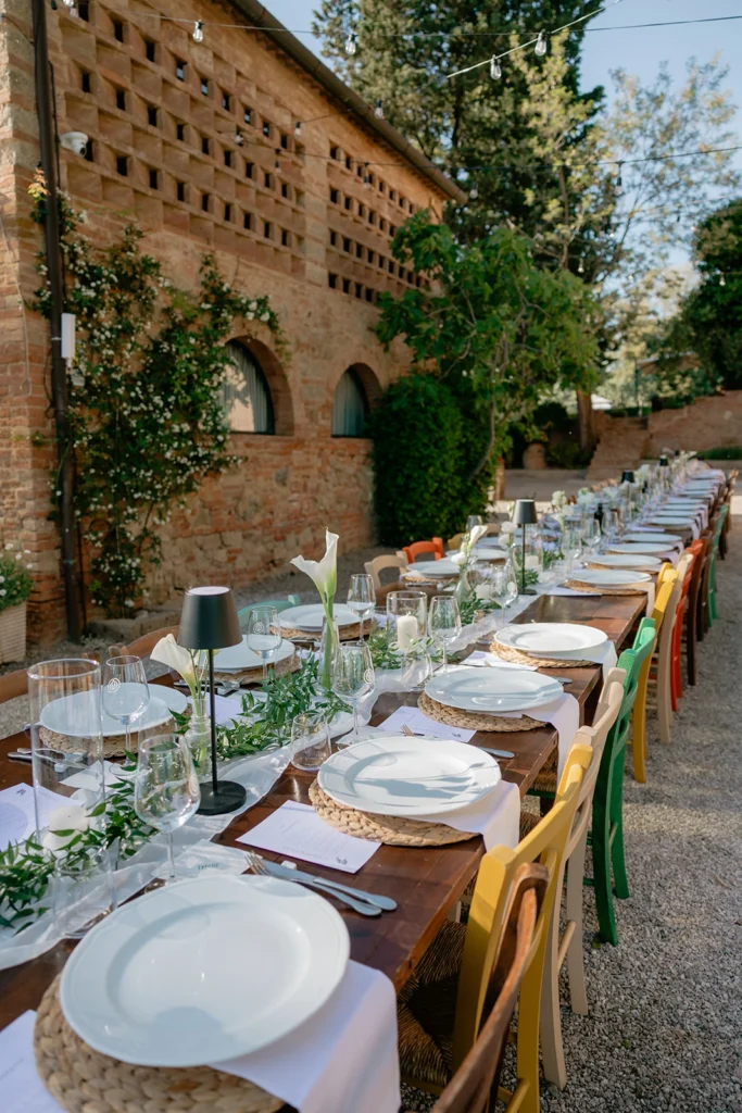 Long Farmhouse Table with Colorful Chairs at Podere San Giorgio, Palaia Tuscany